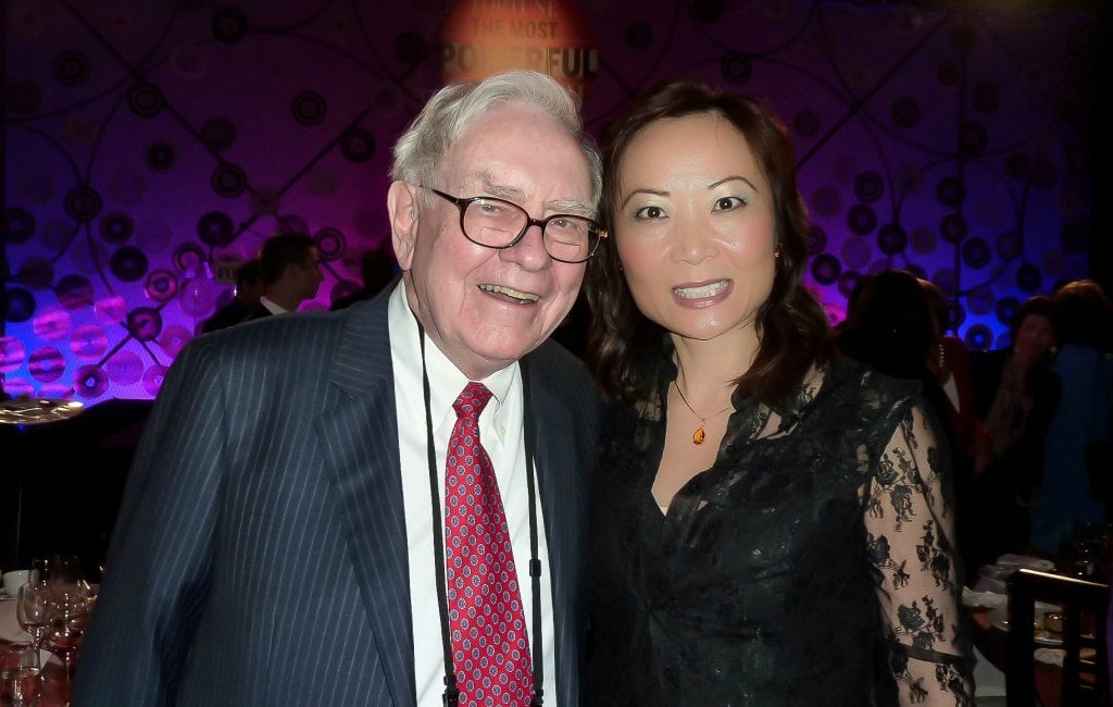 Warren Buffett Jing Ulrich together business meeting conference