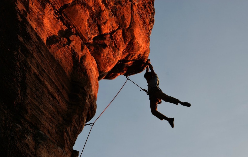 man rock climbing mountain