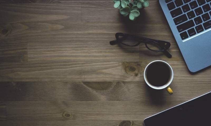 black tea cup laptop table office