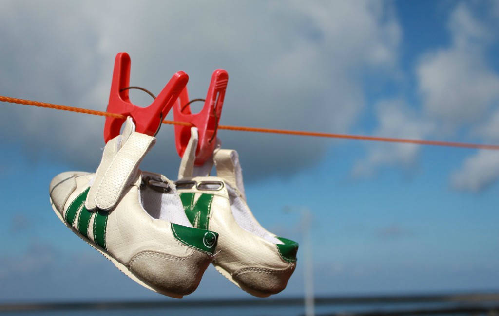 washed and clean shoes hanging rope