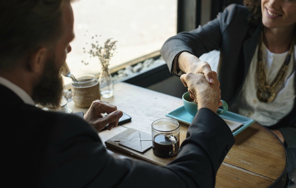 sales person shake hands to crack deal with prospect